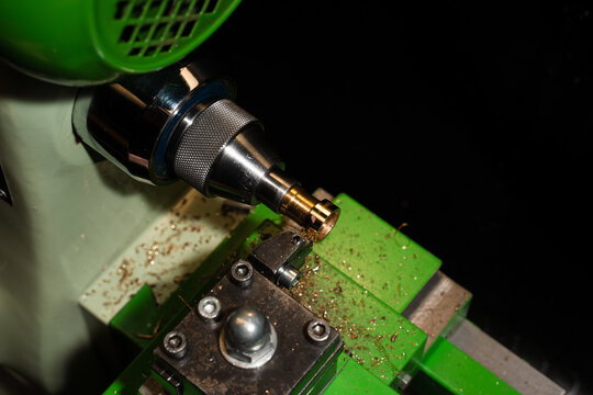 Jeweler milling gold ring on precision machine in workshop.