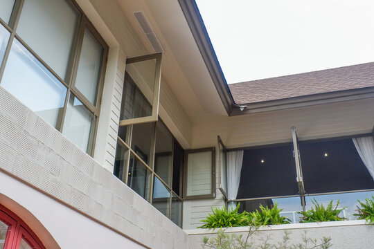 Modern house exterior with casement window and white wall rendering,Large estate minimal home building Window Frame,Cozy home in nature.