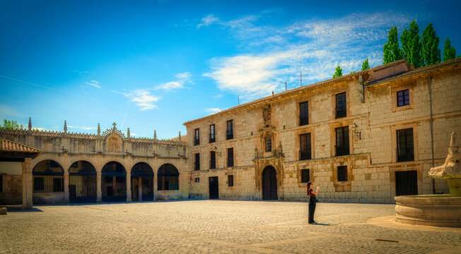 Tourist exploring the historic courtyard of the monastery of santa maria la real de las huelgas in burgos