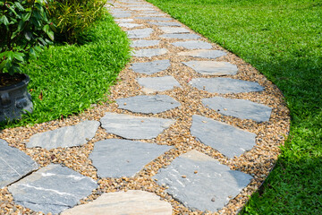 Garden landscape design with pathway in garden and footpath in picturesque summer park and staircase in backyard,Paving stones on floor in park,space for text. © wanatithan