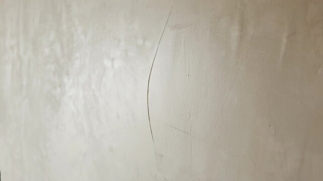 Smoothing plaster on wall surface with float tool close up