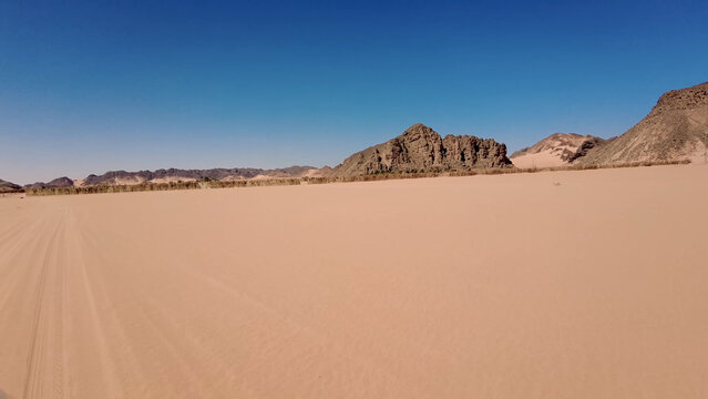 A trip to Sahara desert in Algeria. Beautiful 
african travel photo. Sandy landscapes, mountains, rocks,
dunes, and nature. Summer vacation in arab country.