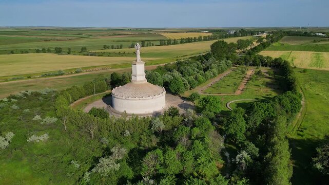 Cinematic aerial drone shot of the Tropaeum Traiani victory monument built by Emperor Trajan. Ancient Roman architecture in Dobrogea region, Adamclisi, Romania.