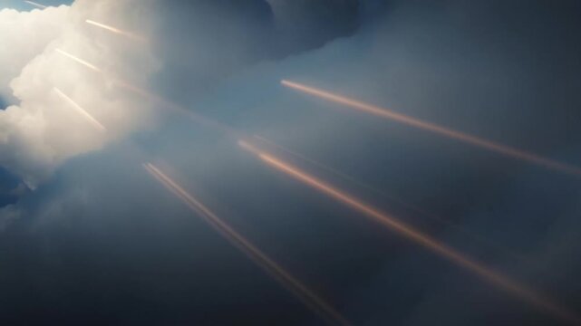 Bright blue sky with soft clouds and radiant sun beams shining through the atmosphere