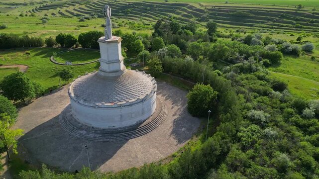 Cinematic aerial drone shot of the Tropaeum Traiani victory monument built by Emperor Trajan. Ancient Roman architecture in Dobrogea region, Adamclisi, Romania.