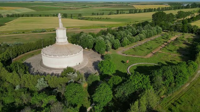 Cinematic aerial drone shot of the Tropaeum Traiani victory monument built by Emperor Trajan. Ancient Roman architecture in Dobrogea region, Adamclisi, Romania.