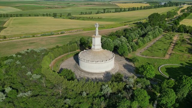 Cinematic aerial drone shot of the Tropaeum Traiani victory monument built by Emperor Trajan. Ancient Roman architecture in Dobrogea region, Adamclisi, Romania.