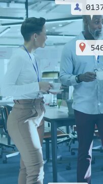 Vertical video: Office duo holding cups chatting during break timed bubbles appearing around them