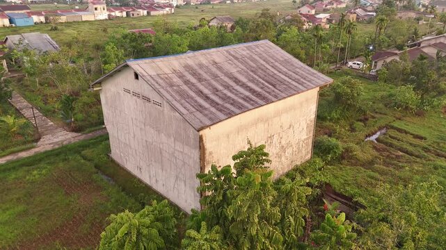An aerial view from a high vantage point showing a swiftlet house in Indonesia&rsquo;s tropical landscape.