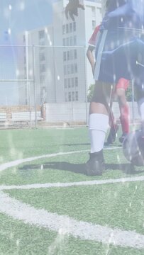 Vertical video: Red player coming, blue player holding soccer ball center reacting, sparkle on turf
