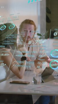 Vertical video: Team reviewing finance HUD on glass, projected percents driving target discussion