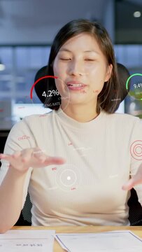 Vertical video: Business woman seeing data appearing, talking, tapping papers and showing ENG 4