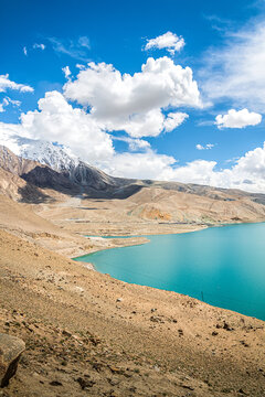 Stunning Baisha Lake landscape with clear blue water and snow mountains, tranquil alpine lake scenery in Kizilsu, Pamir Plateau, Xinjiang