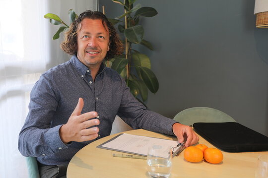 Man Discussing Business Over Oranges