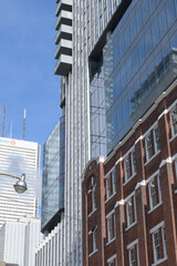 Obraz premium exterior of 19 Duncan, designed by Hariri Pontarini Architects, mixed-use integration of the heritage Southam Press Building and a modern 58-storey tower, housing Thomson Reuters offices