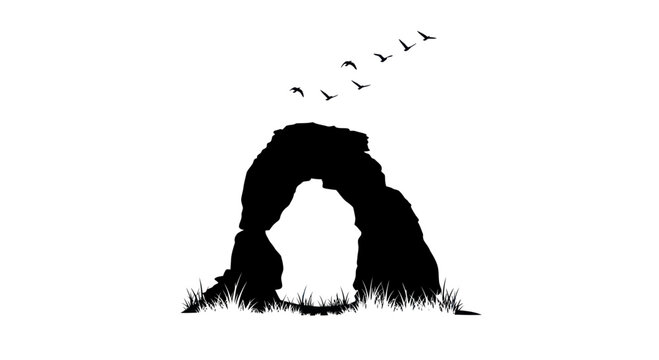 Silhouette of natural rock arch with birds flying overhead and grass at base