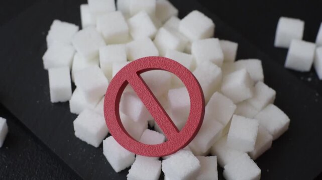 The sugar ban sign as a concept to stop the problem of diabetes and obesity, a call to diet. The sugar ban sign as a background for your design