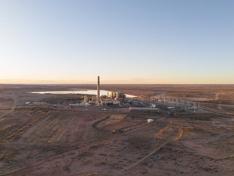 Joseph City, United States - 05 April 2026: Aerial view of Cholla Power Plant with its tall chimney and industrial structures situated in the arid desert landscape under a clear sky.