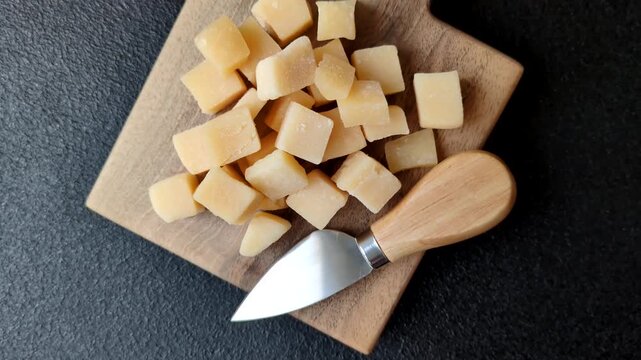 Parmesan cheese cubes for pasta, salads, and other Italian dishes. Parmesan cheese as a food background for your design