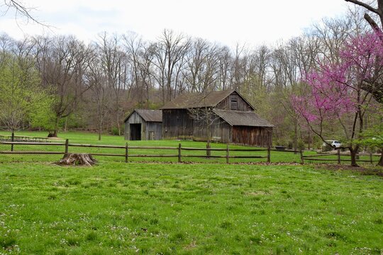 The old brown barn in the country on a cloudy day.