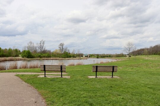 The benches at the park on a cloudy spring day.