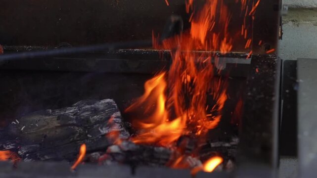 Intense Fire Flames Close-Up, Stoking with Pickaxe in Slow Motion