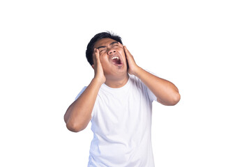 Fototapeta premium Stressed young Asian man in white t-shirt holding his head and screaming in frustration against white background.