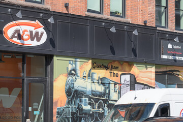 Obraz premium exterior building and sign of A&W Canada, a hamburger restaurant chain, located here at 2858 Dundas St W (northwest corner) in historic Campbell Block, The Junction, Toronto