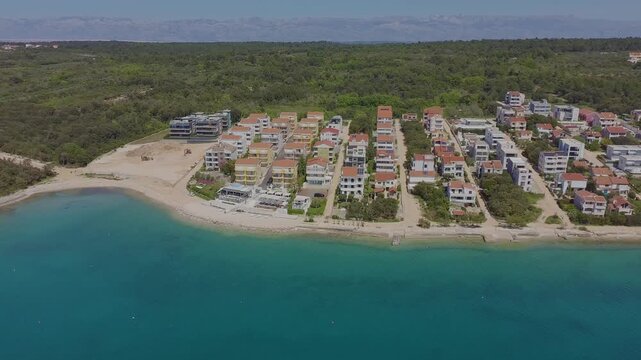 Aerial drone view of Kozino town in Croatia with beach modern tourist apartment buildings.