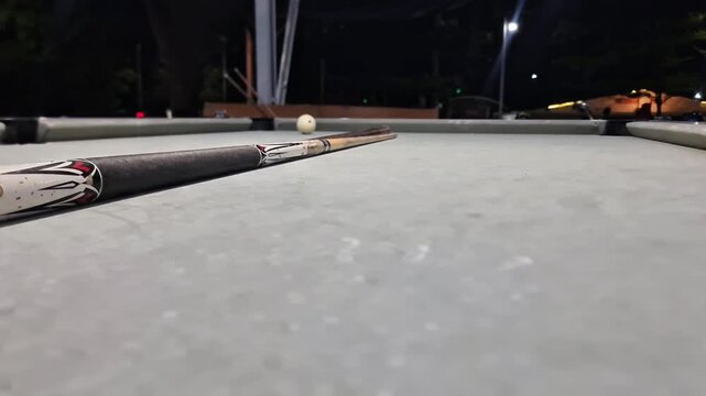 Low Angle Billiards Shot Cue Stick and Ball on Pool Table, Sport Action Close Up