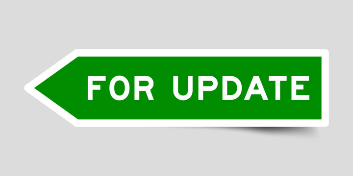 Green color arrow shape sticker label with word for update on gray background
