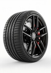 Obraz premium High performance car tire on a black glossy multi spoke rim with red brake calipers isolated on white background.