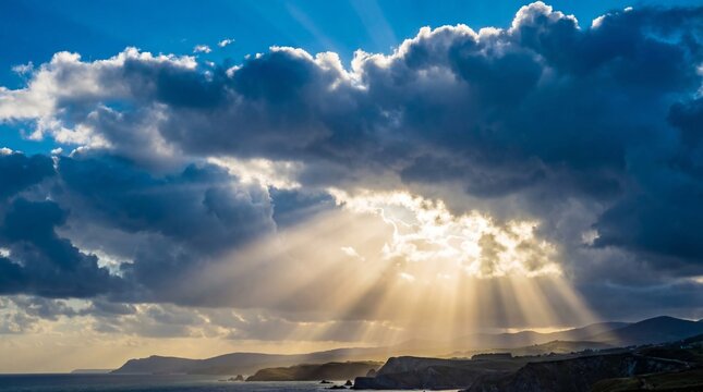 Sun rays breaking through clouds over the ocean, dramatic landscape with natural light creating a peaceful scenic view