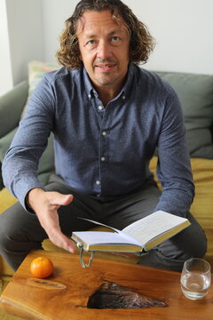 Man Reading a Book on Sofa
