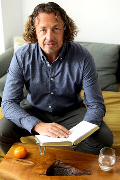 Man Reading a Book Indoors
