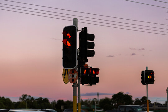Red stop traffic lights intersection at dusk