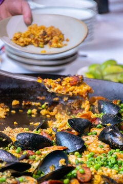 Close up of serving Paella - vertical