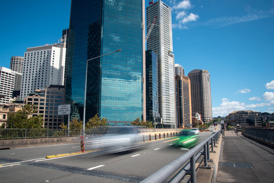 Cars driving on Cahill Expressway with city buildings and skyline in the background