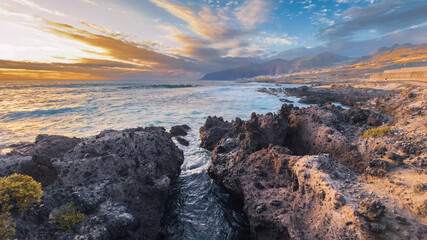 Golden hour light over rocky ocean coast in tropical island Tenerife Spain © Victoria Schaad