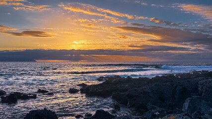 Obraz premium Golden hour light over rocky ocean coast in tropical island Tenerife Spain