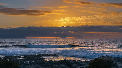 Obraz premium Golden hour light over rocky ocean coast in tropical island Tenerife Spain