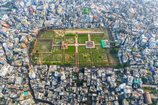 Dhaka, Bangladesh - 08 March 2026: Aerial view of Lalbagh Fort with its geometric gardens and historic structures surrounded by the dense urban sprawl of the city.