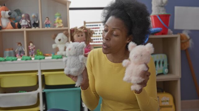 Woman holding two teddy toys and moving them like puppets in a playroom building; playfulness nurturing joy.