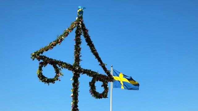 Midsummer festival in Sweden.Dancing around a pole celebrating middle of summer