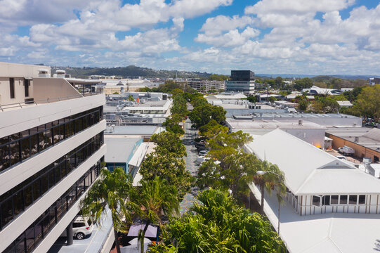 aerial view of tree lined main street in a small coastal town