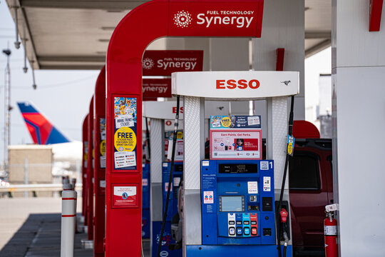 Close up of Esso gas pump with Synergy fuel technology sign. Toronto, Canada - April 23, 2026.