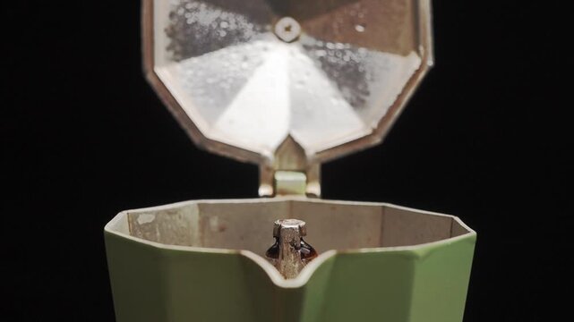 Close-up of opening Moka pot with boiled espresso coffee