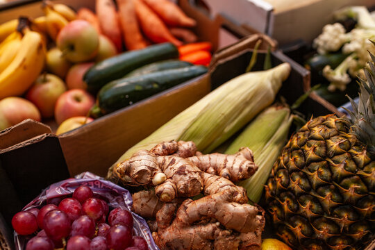 Ginger, grapes, pineapple and corn in box at fresh food hub