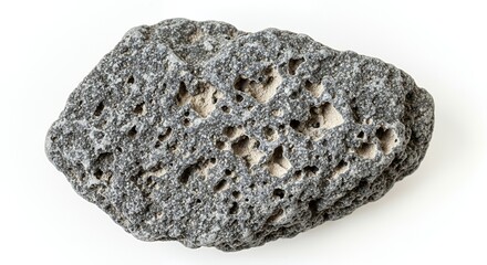 Fototapeta premium Close-up of a dark gray porous volcanic rock, isolated on a white background, showcasing its unique texture and geological formation.