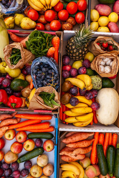 Colourful overhead angle of fresh organic fruit and vegetable boxes at unsupermarket food hub
